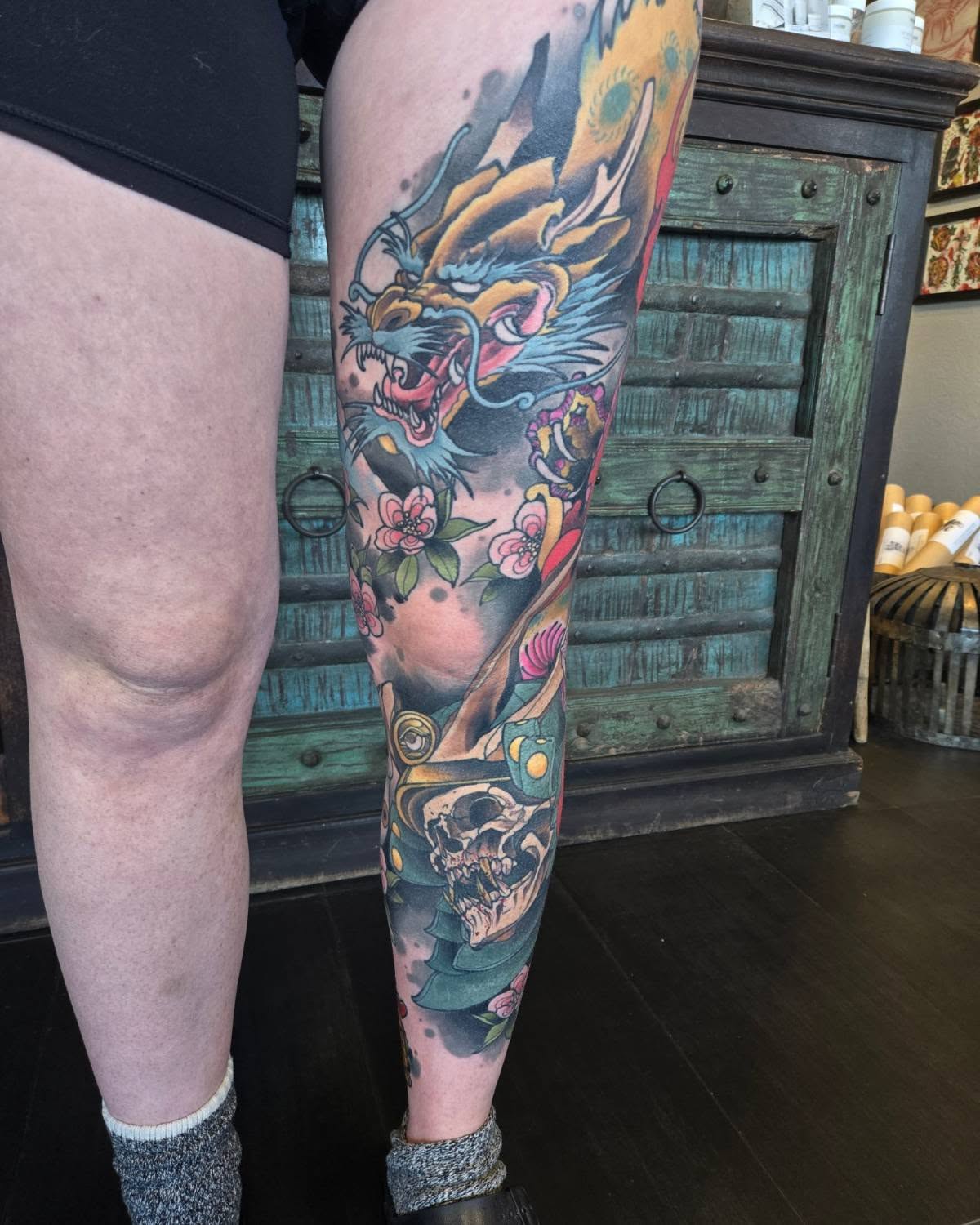 Dragon and skull new school tattoo on the calf by Brian Savage, Gilbert, Arizona