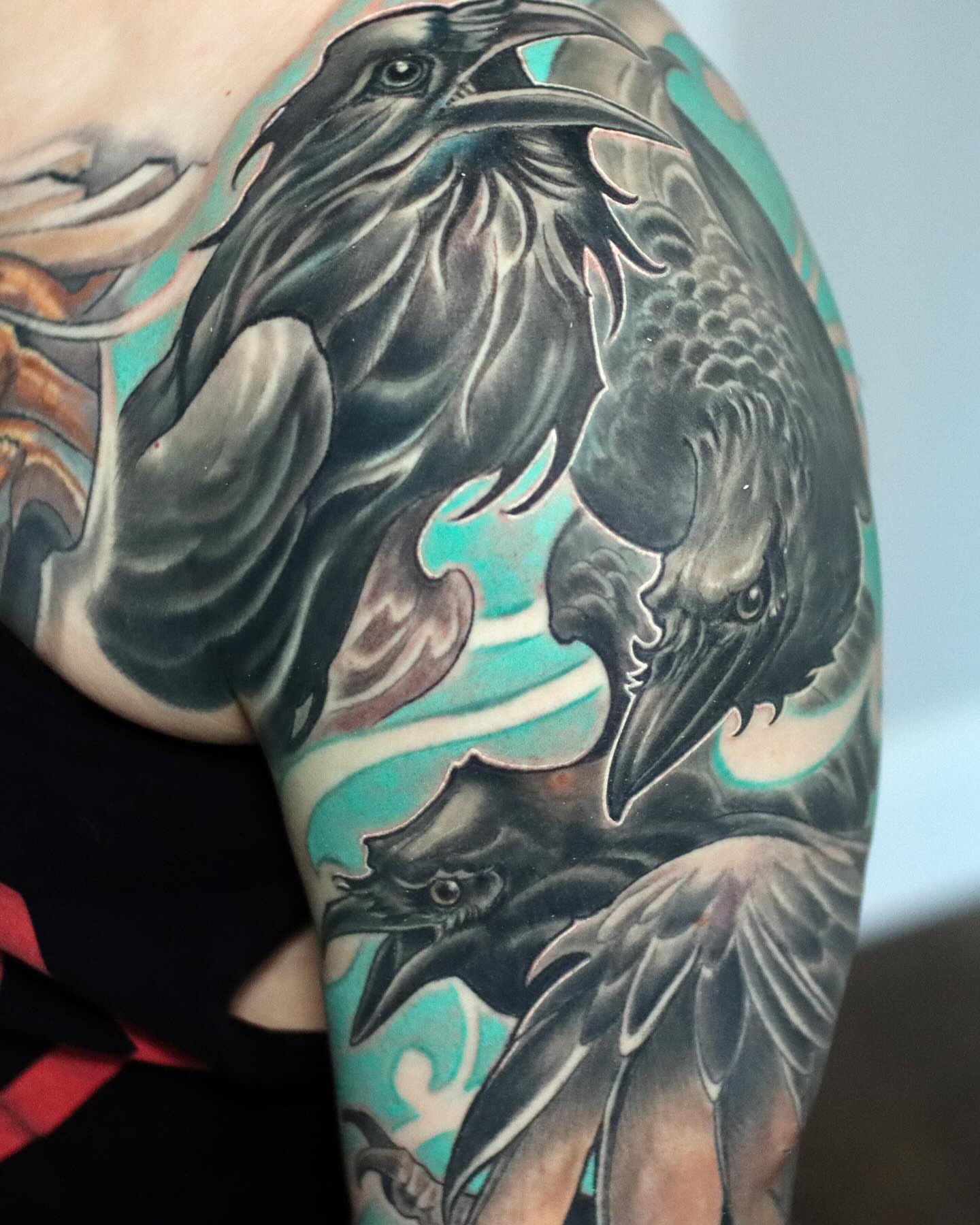Ravens realism tattoo on the shoulder by Marvin Silva