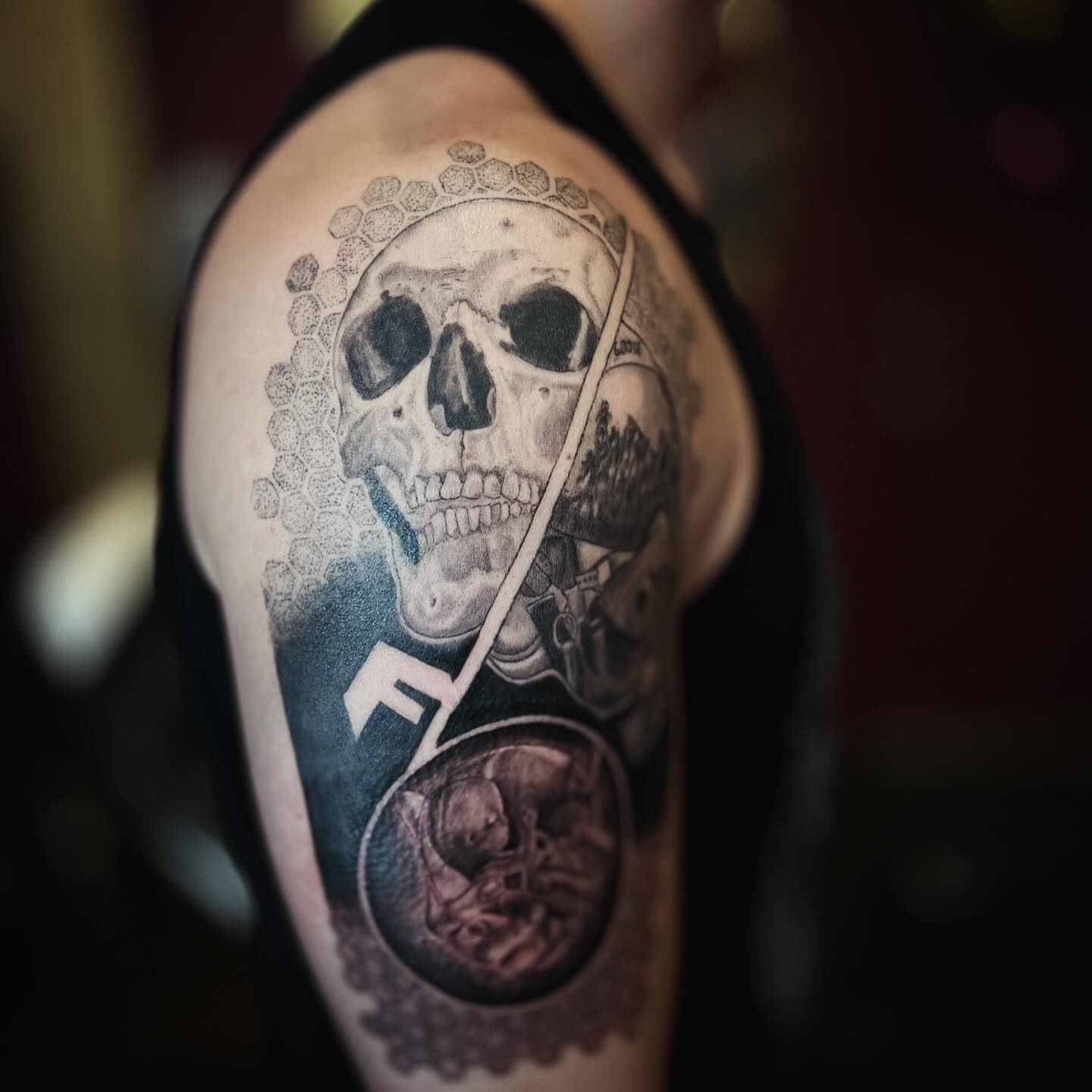 Skull and coin realism tattoo on the shoulder by Romi Utah Tattoo