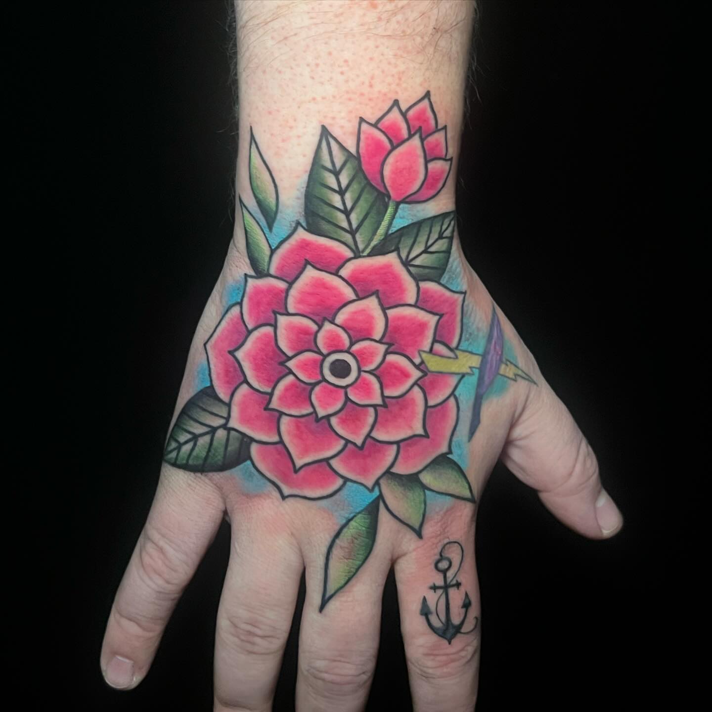 Flower and arrow American traditional tattoo on the hand by Blu