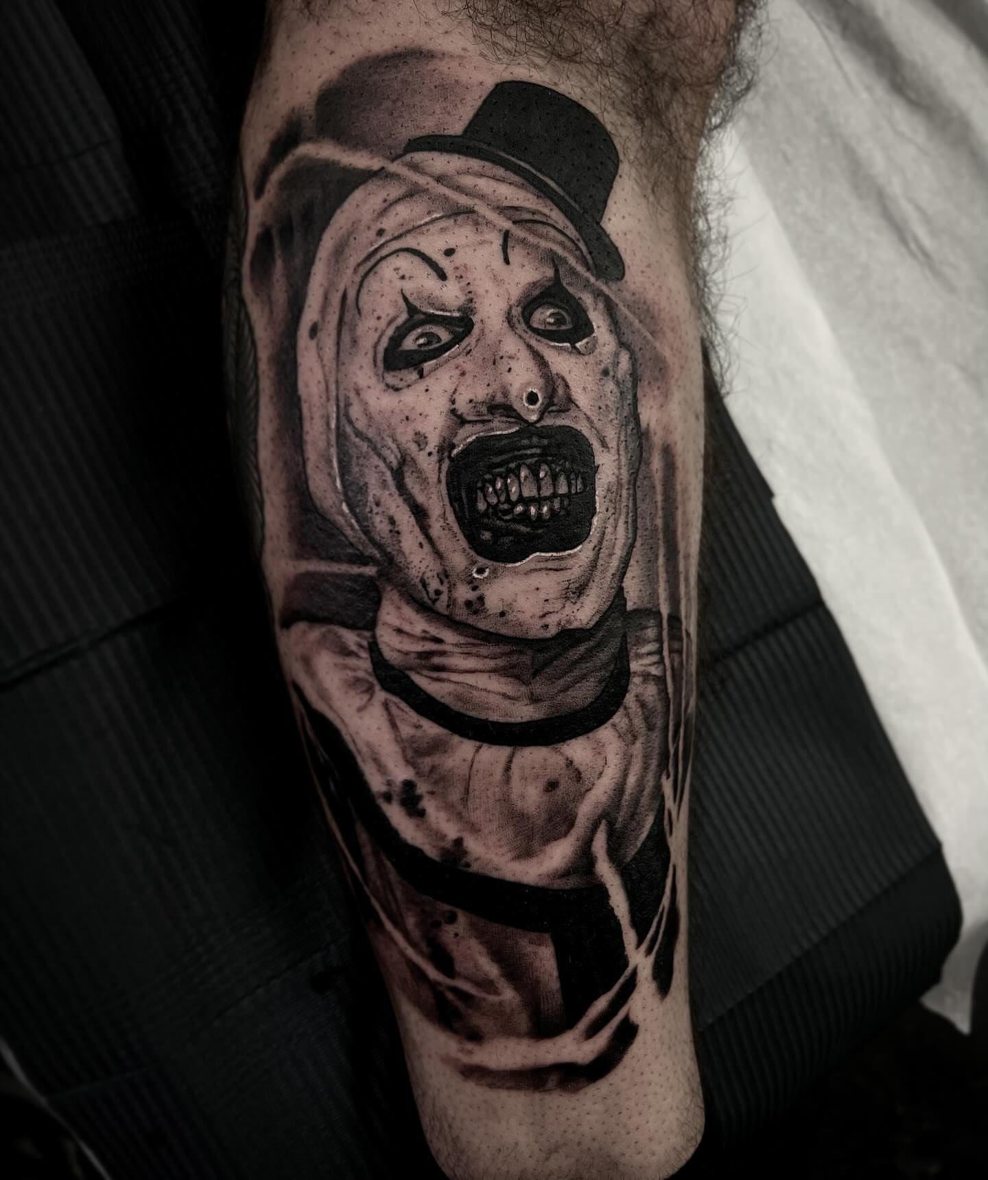Clown realism tattoo on the forearm by Briana Walker