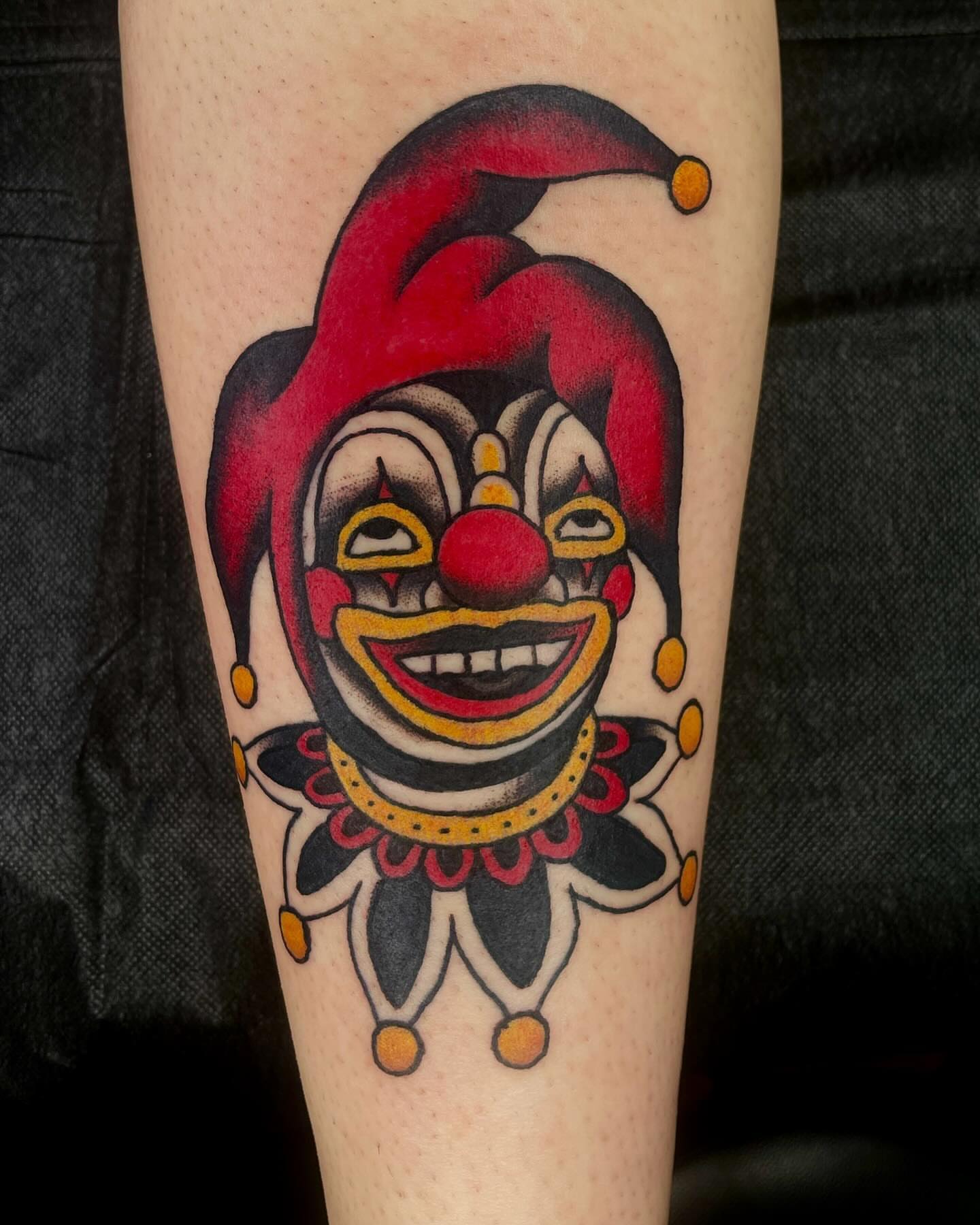 Clown jester American traditional tattoo on the forearm by Meg Nefcy, Milford, Michigan