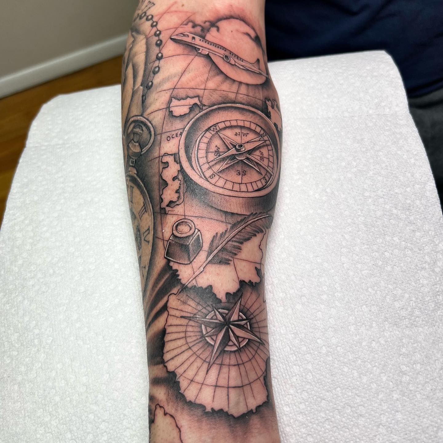 Compass and map realism tattoo on the forearm by Denis Morello de Castro, South River, New Jersey
