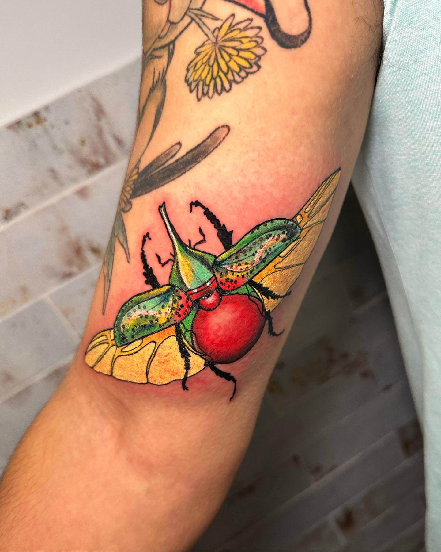 Firefly beetle realism tattoo on the forearm by Marta La Jirafa