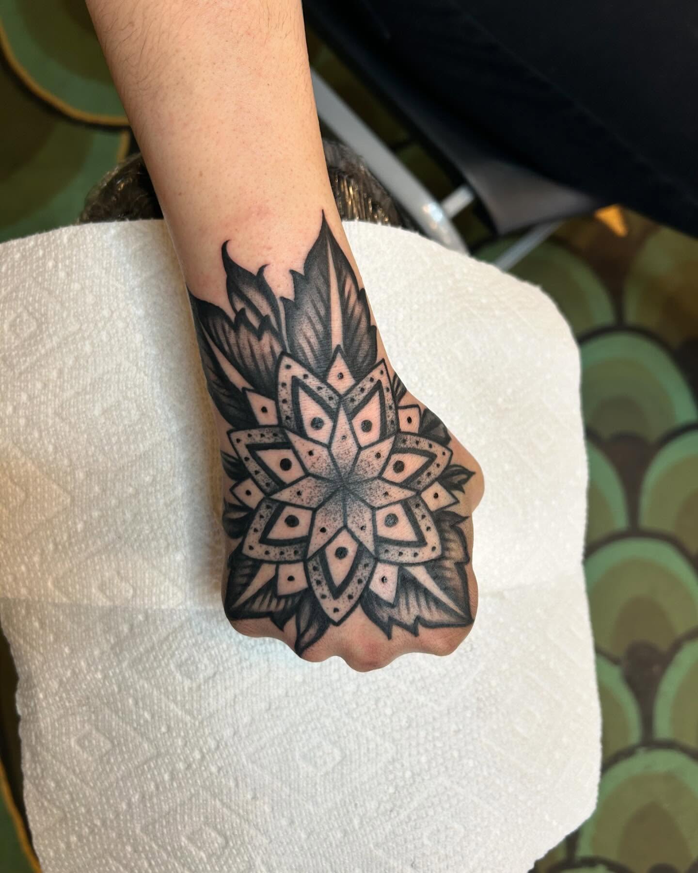 Geometric mandala dotwork tattoo on the forearm by Sam Perry, Denver, Colorado