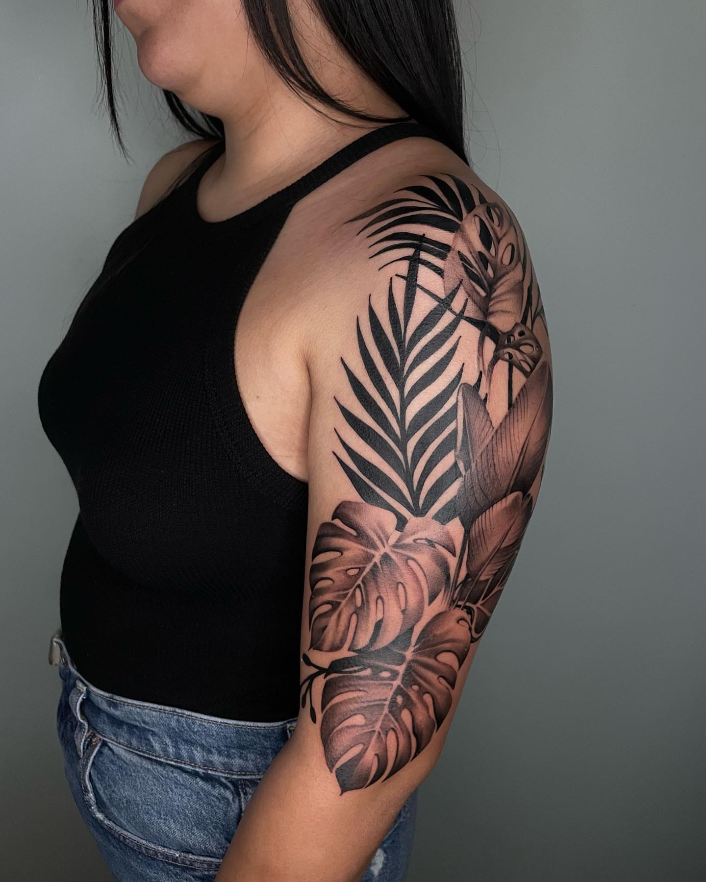 Tropical leaves and butterfly realism tattoo on the upper arm by Angel, Salt Lake City, Utah