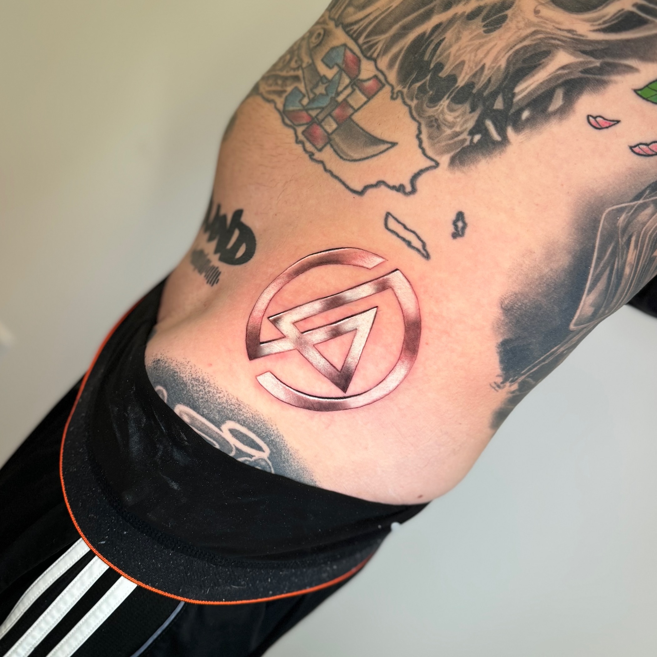 Geometric symbol geometric tattoo on the forearm by Mel