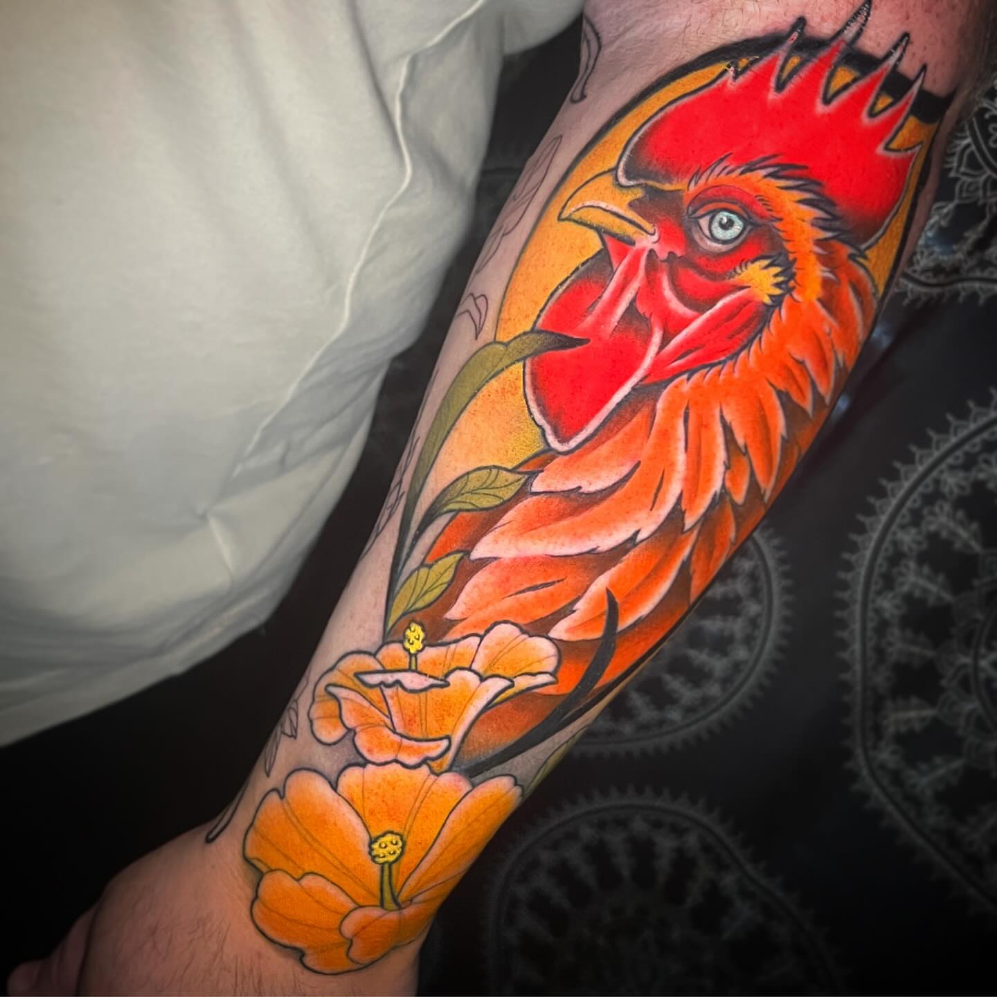 Rooster and poppies American traditional tattoo on the forearm by Julio Ferrer