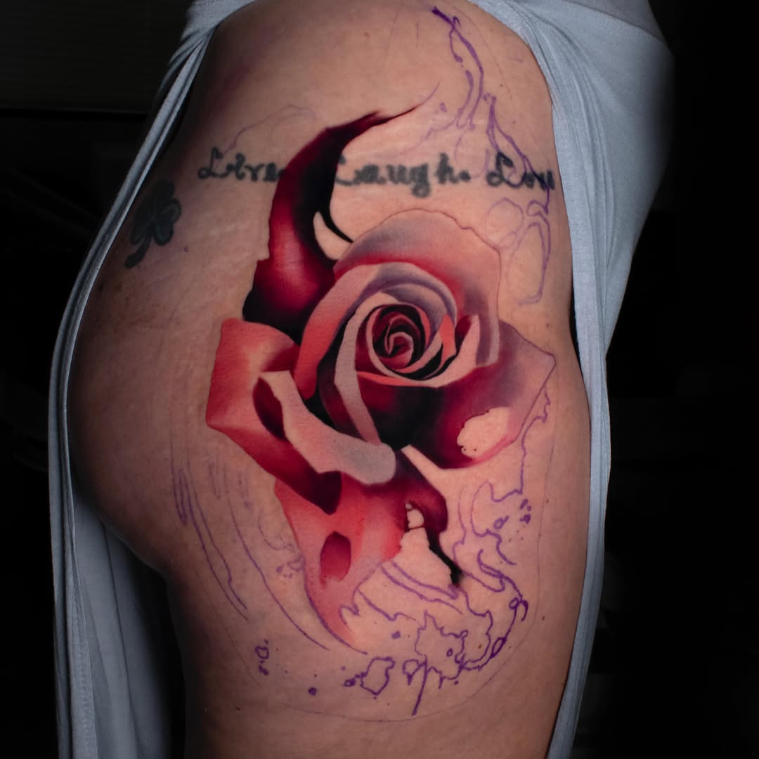 Red rose realism tattoo on the thigh by Luke Benavidez