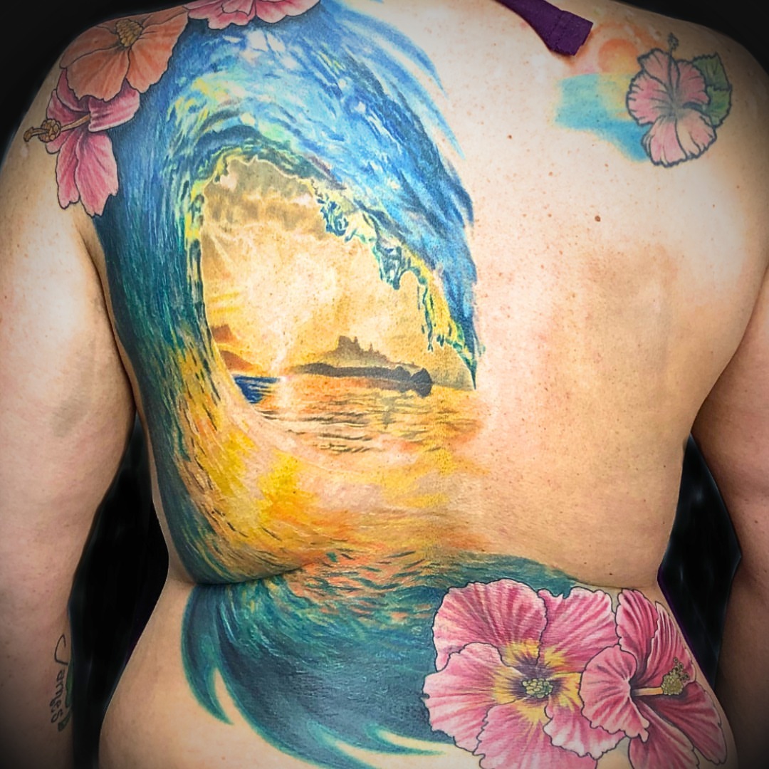 Wave and sunset watercolor tattoo on the back by Jordan Rookus