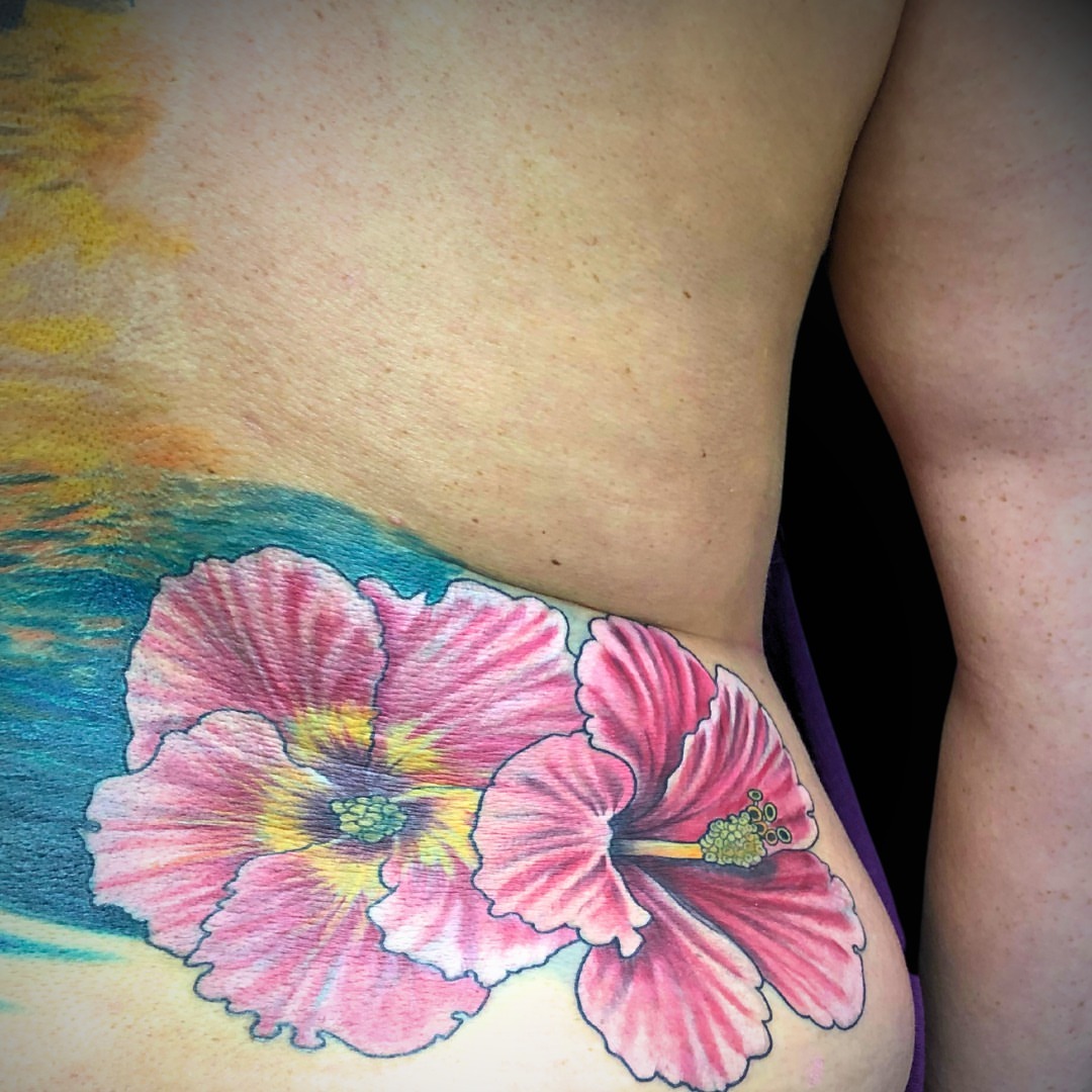 Hibiscus flower realism tattoo on the ribs by Jordan Rookus