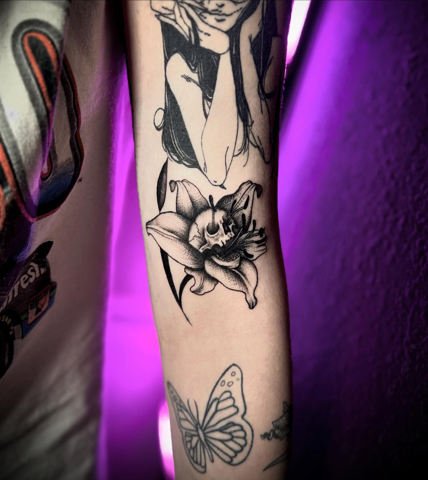 Lily with skull black and grey tattoo on the forearm by Tattoo Artist based in Dallas Tx