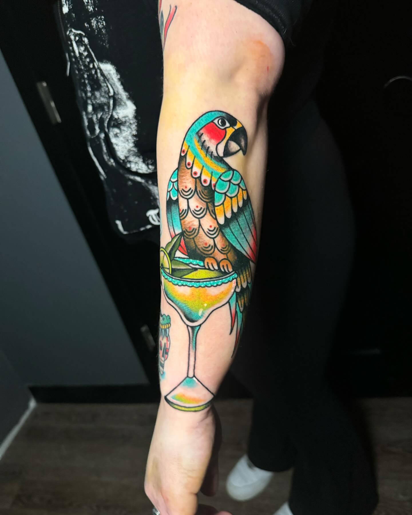 Parrot new school tattoo on the forearm by Nate Masi