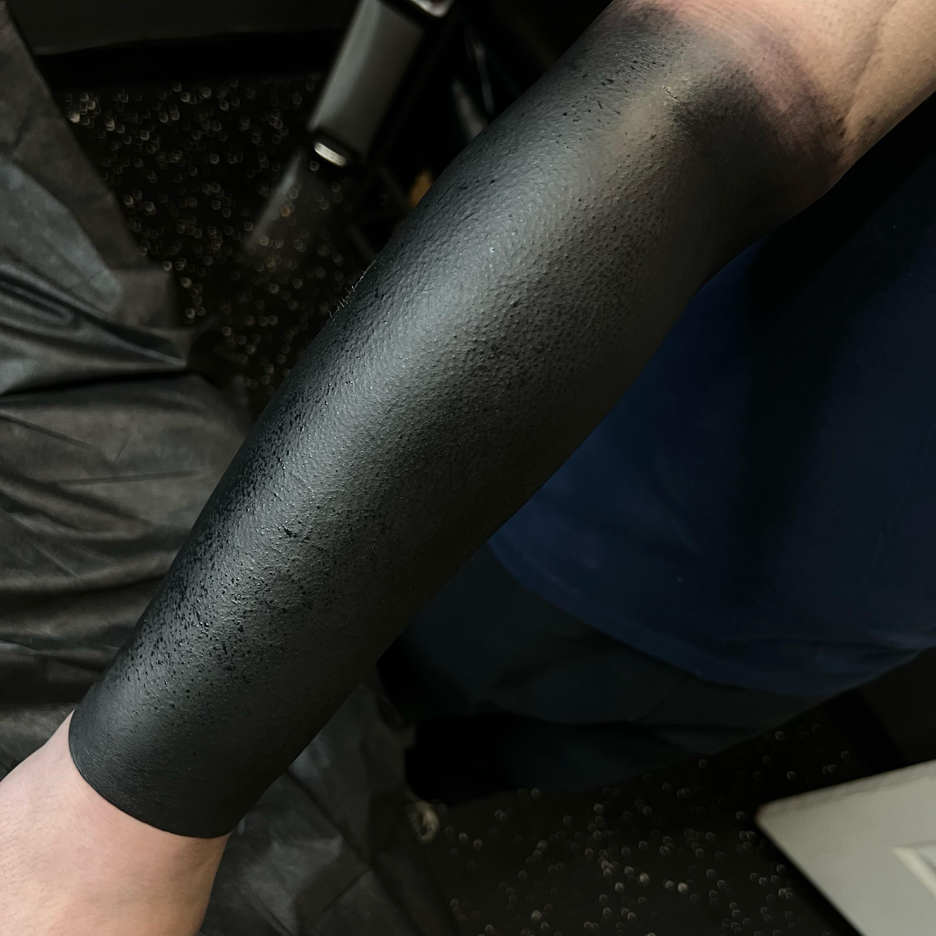 Blackout blackwork tattoo on the forearm by Kyle Black