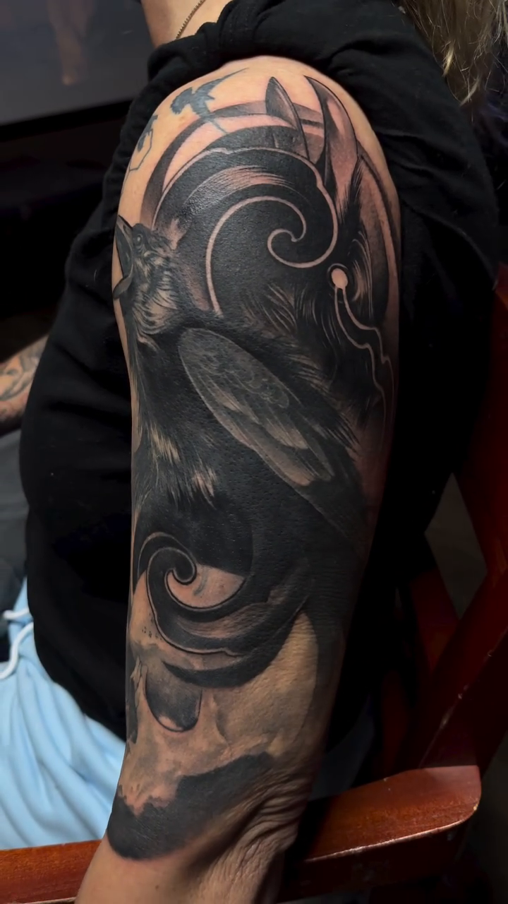 Raven and skull realism tattoo by Anwon Johnson