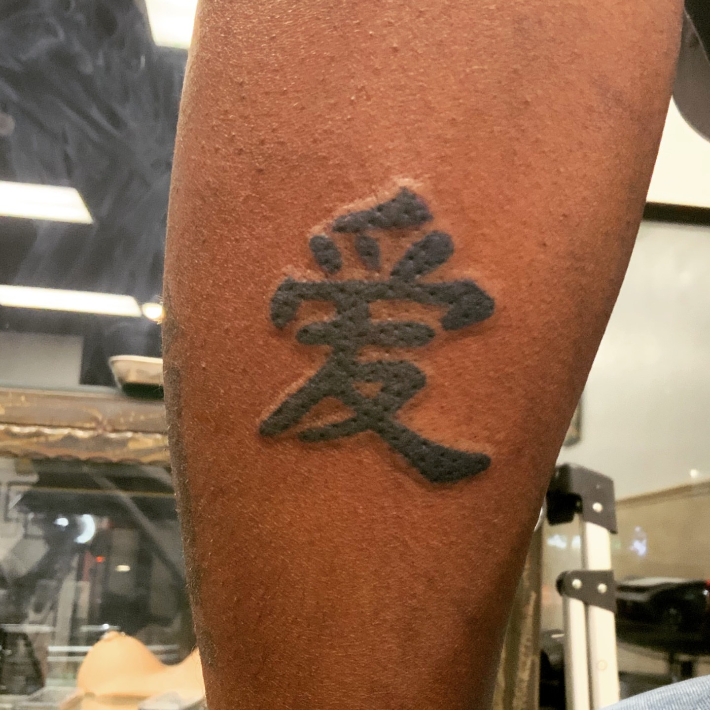 Love black and grey tattoo on the forearm by Lopez Dautruche