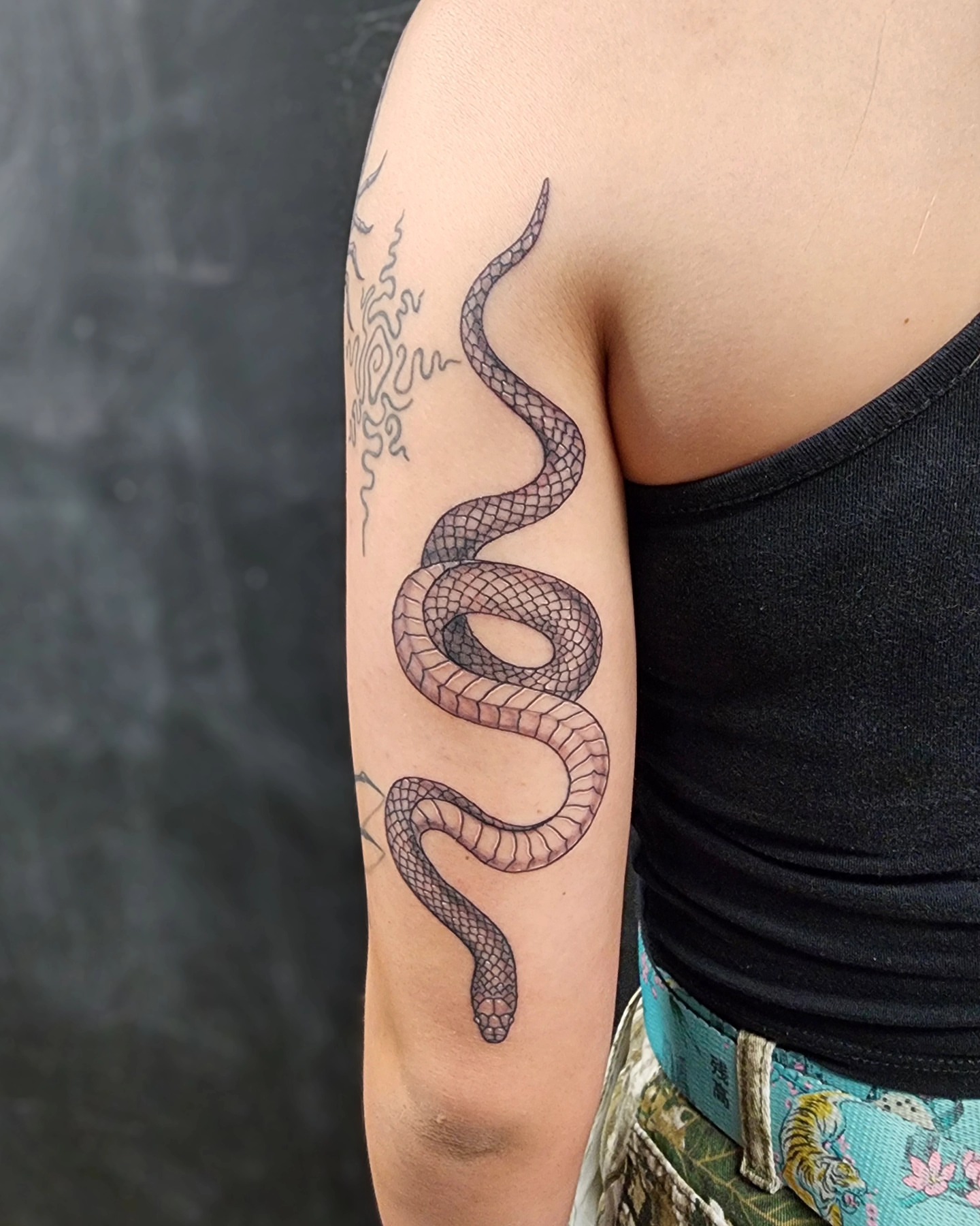 Snake black and grey tattoo on the forearm by Bry True