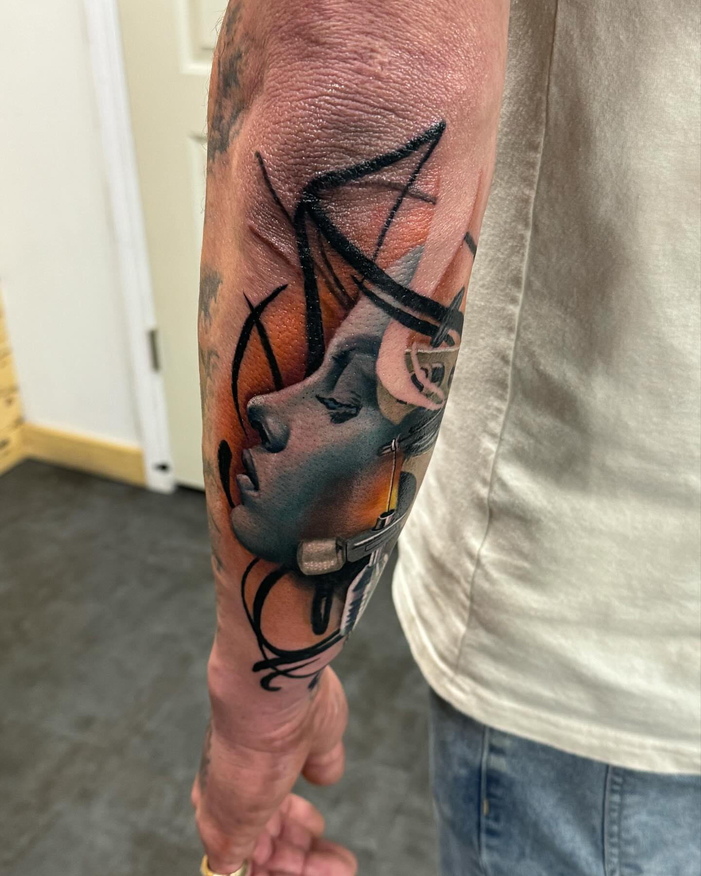 Woman with bicycle realism tattoo on the forearm by Zach Ashton