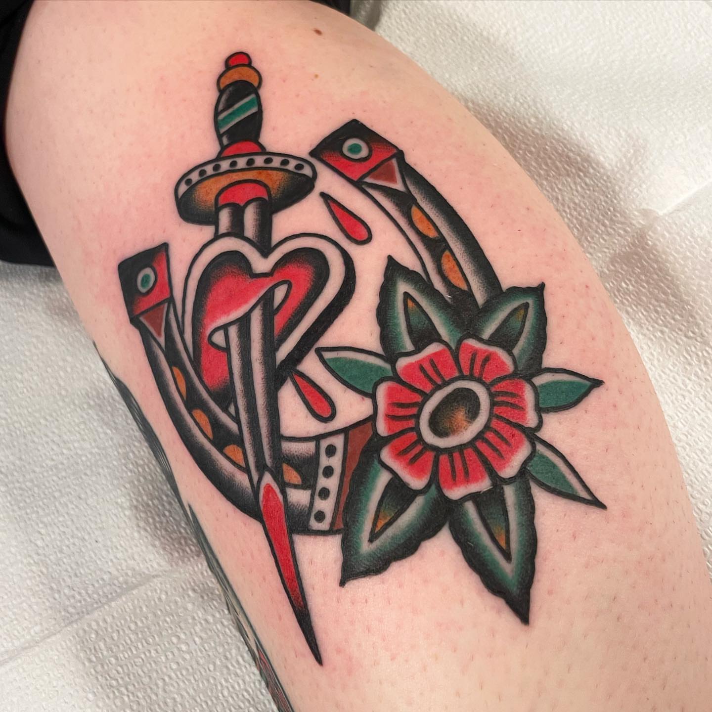 Sword and heart American traditional tattoo on the thigh by Mike Hudgins