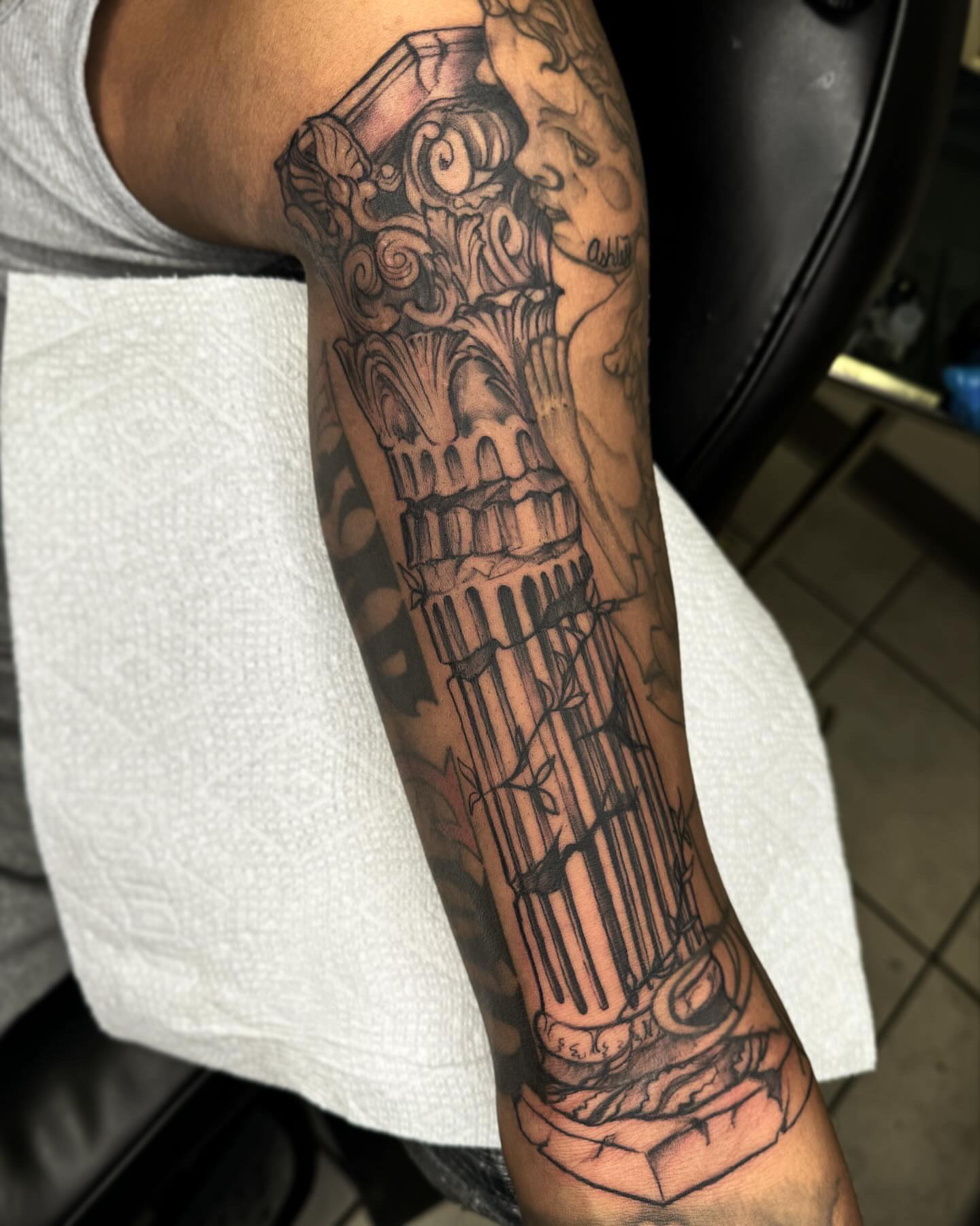 Column black and grey tattoo on the forearm by @inkhazmat