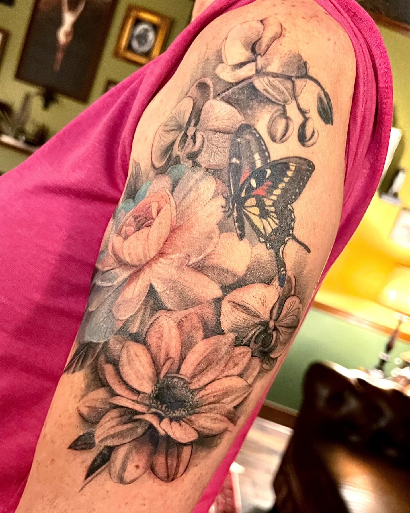 Flowers and butterfly realism tattoo on the forearm by Tattoos by Alli Wilcox