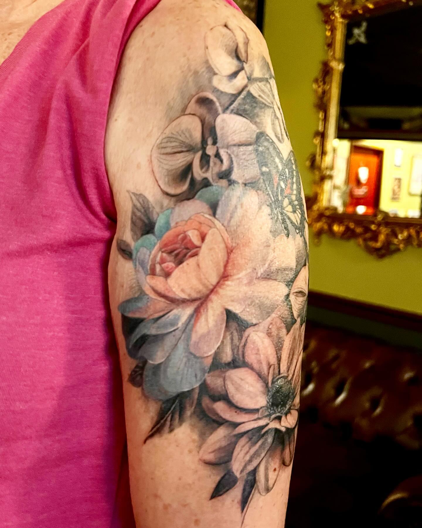 Floral bouquet realism tattoo on the upper arm by Tattoos by Alli Wilcox