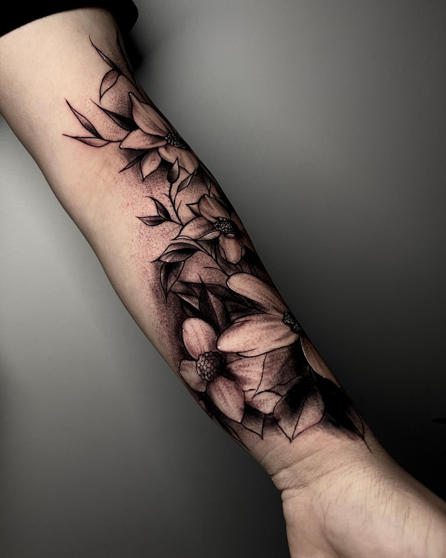 Flowers dotwork tattoo on the forearm by Jesse Temores