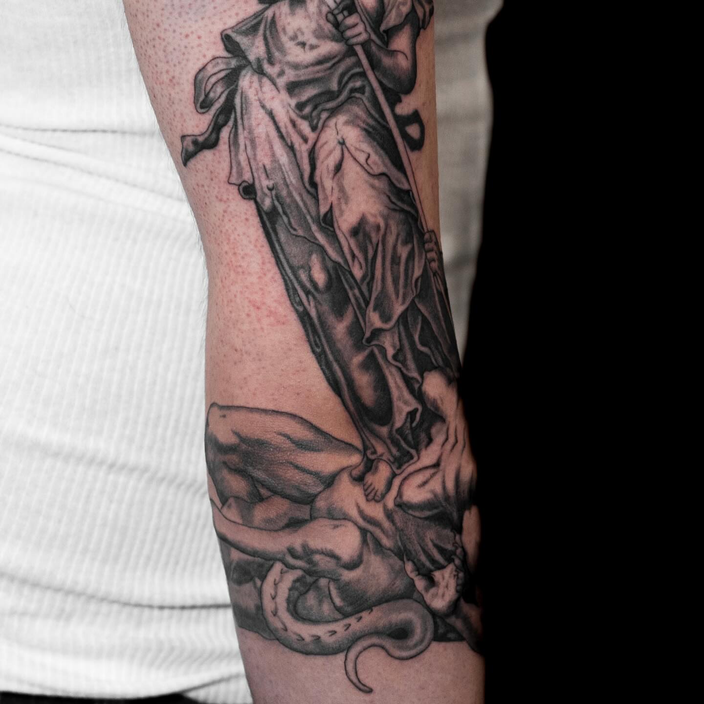 Statue and snake realism tattoo on the forearm by Tattoo Artist