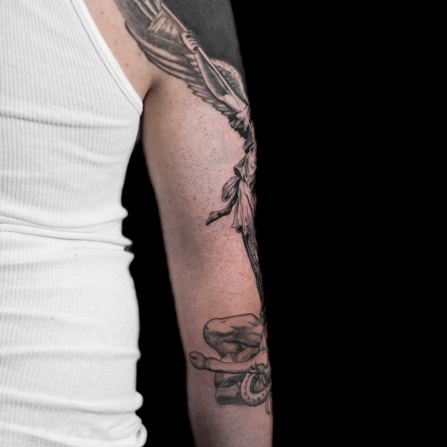 Angel with sword black and grey tattoo on the forearm by Tattoo Artist