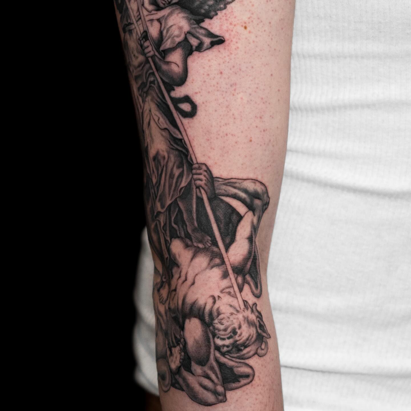 Angel and demon realism tattoo on the forearm by Tattoo Artist
