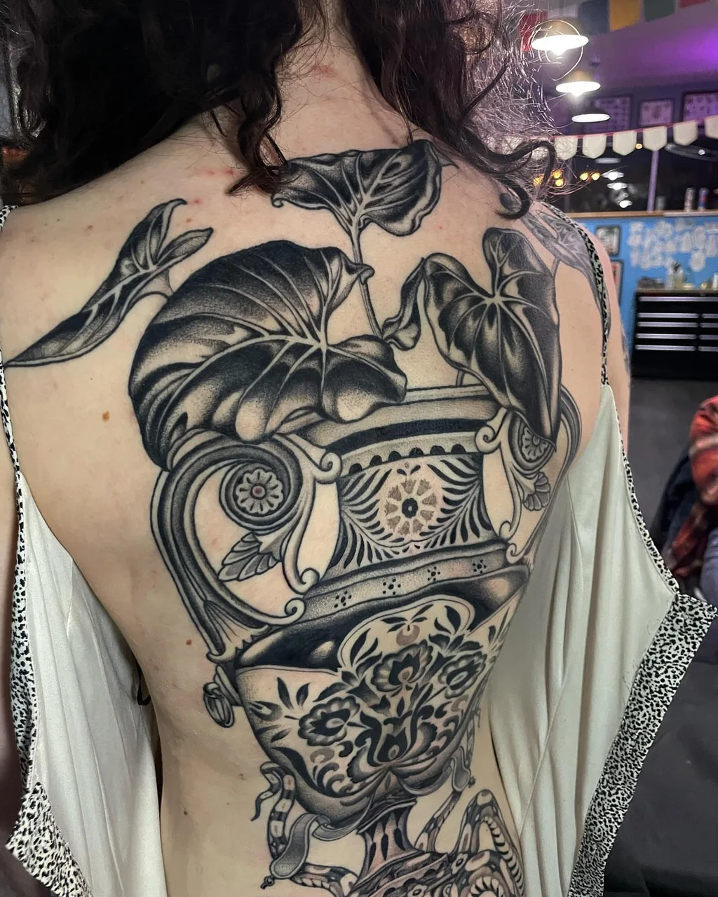Monstera plant in pot realism tattoo on the back by Lauren Vandevier