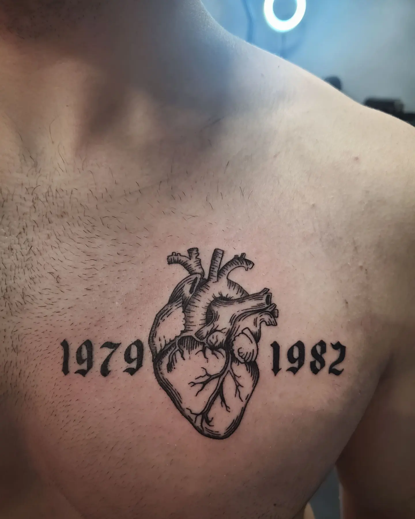 Heart black and grey tattoo on the chest by Shailey Pasquale