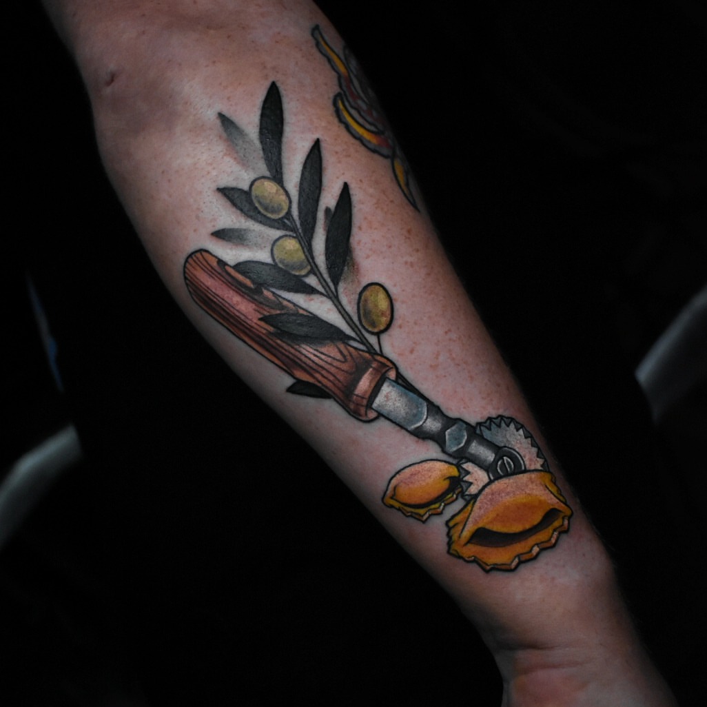 Olive branch and knife American traditional tattoo on the forearm by Ciani Holman