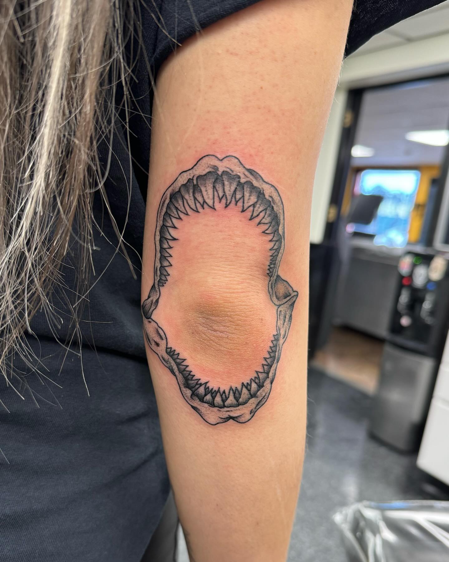 Jaws black and grey tattoo on the forearm by Cory Perry-Servellon