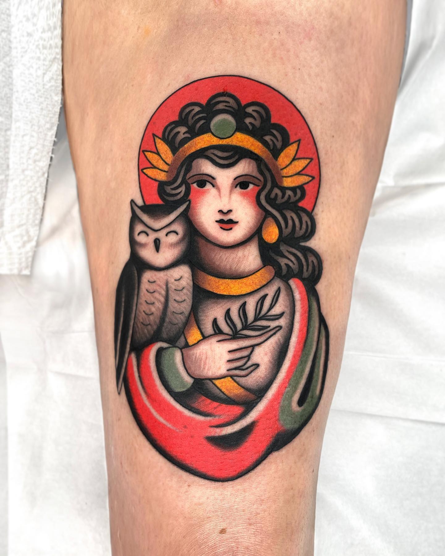 Woman with owl American traditional tattoo on the thigh by Wes Hoffman