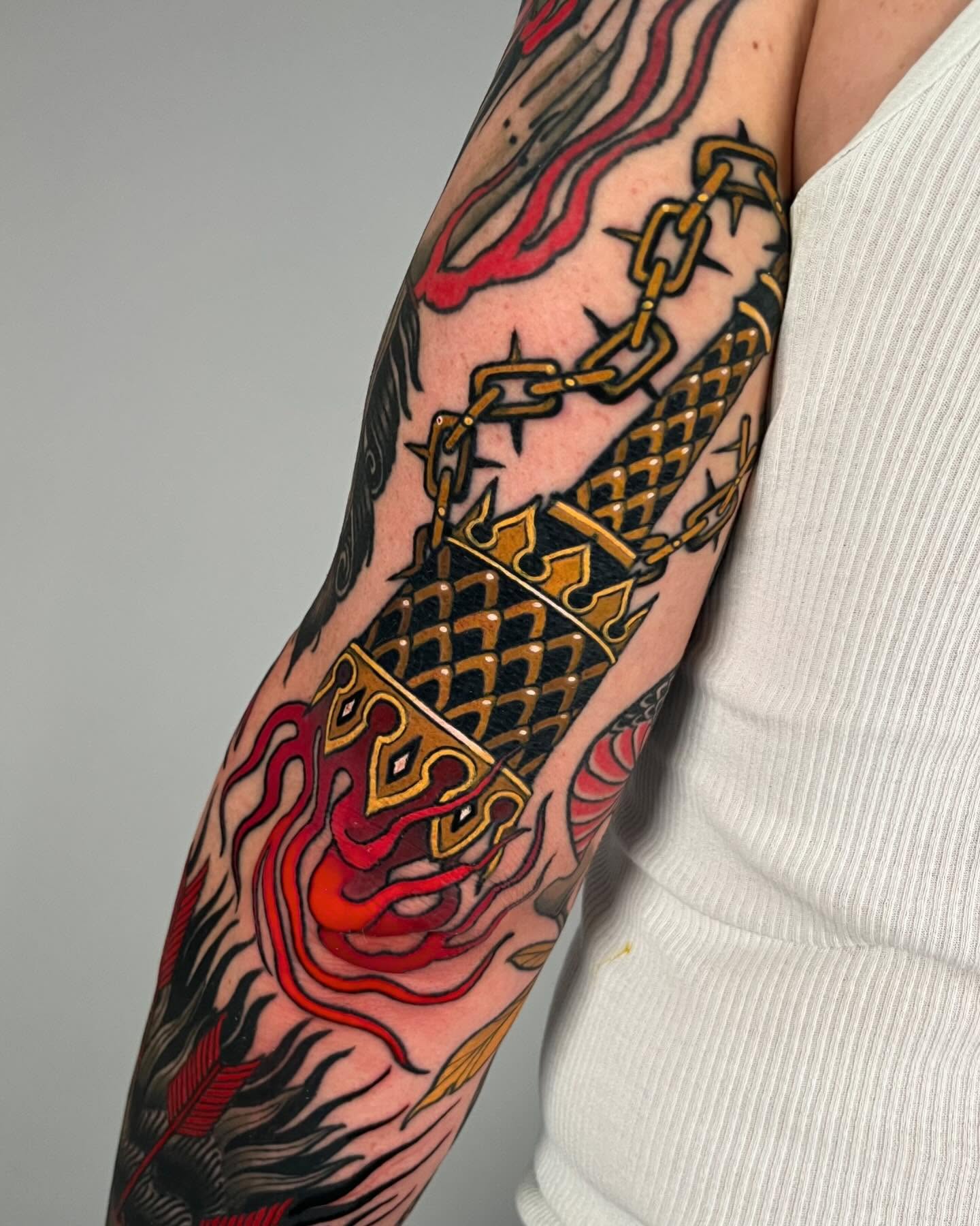 Dragon and chain American traditional tattoo on the forearm by Sara Lewis