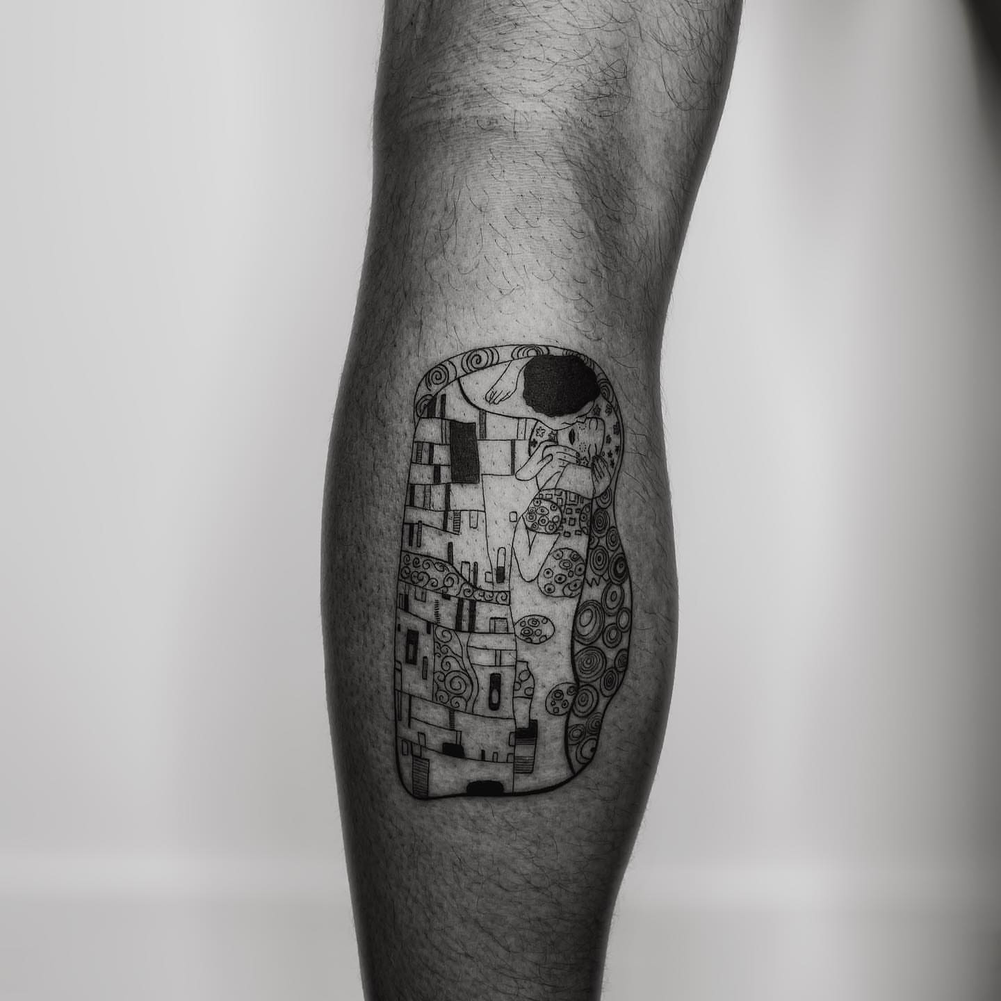 The kiss black and grey tattoo on the forearm by Marisa Martello, Nashville, Tennessee