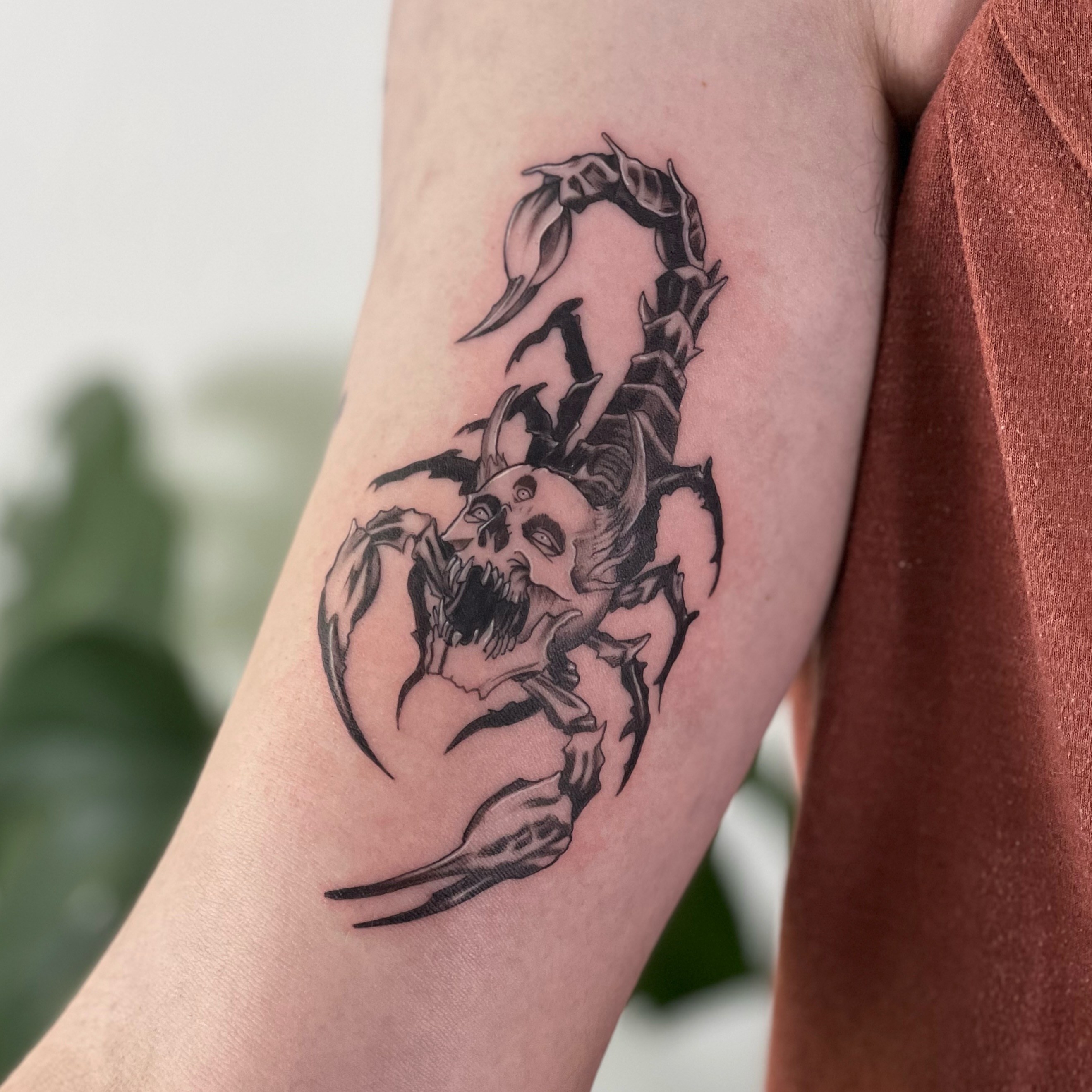 Scorpion and skull dark realism tattoo on the forearm by Riki