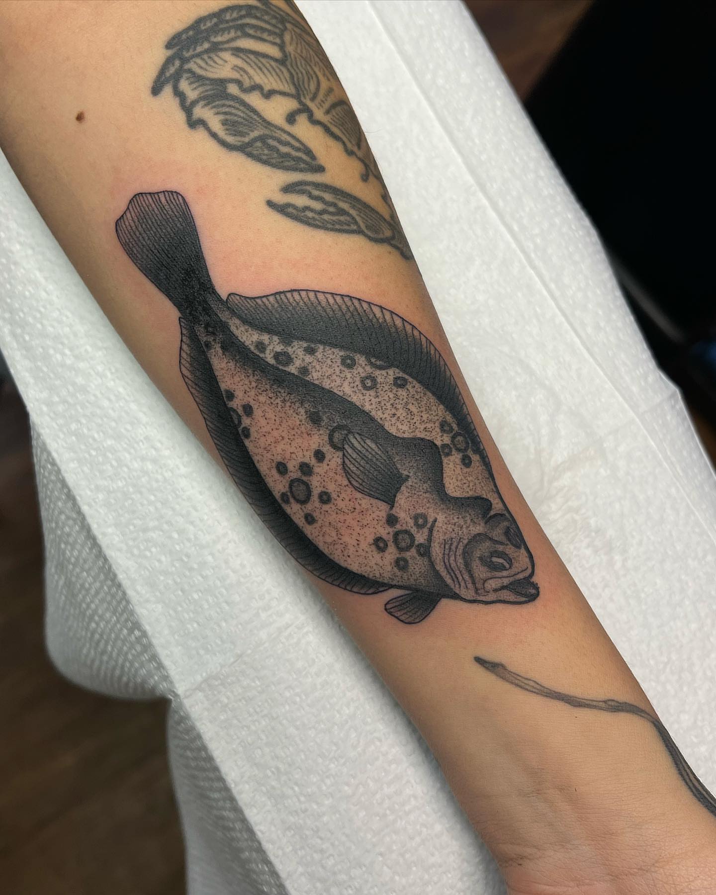 Fish dotwork tattoo on the forearm by Daniel Patrick