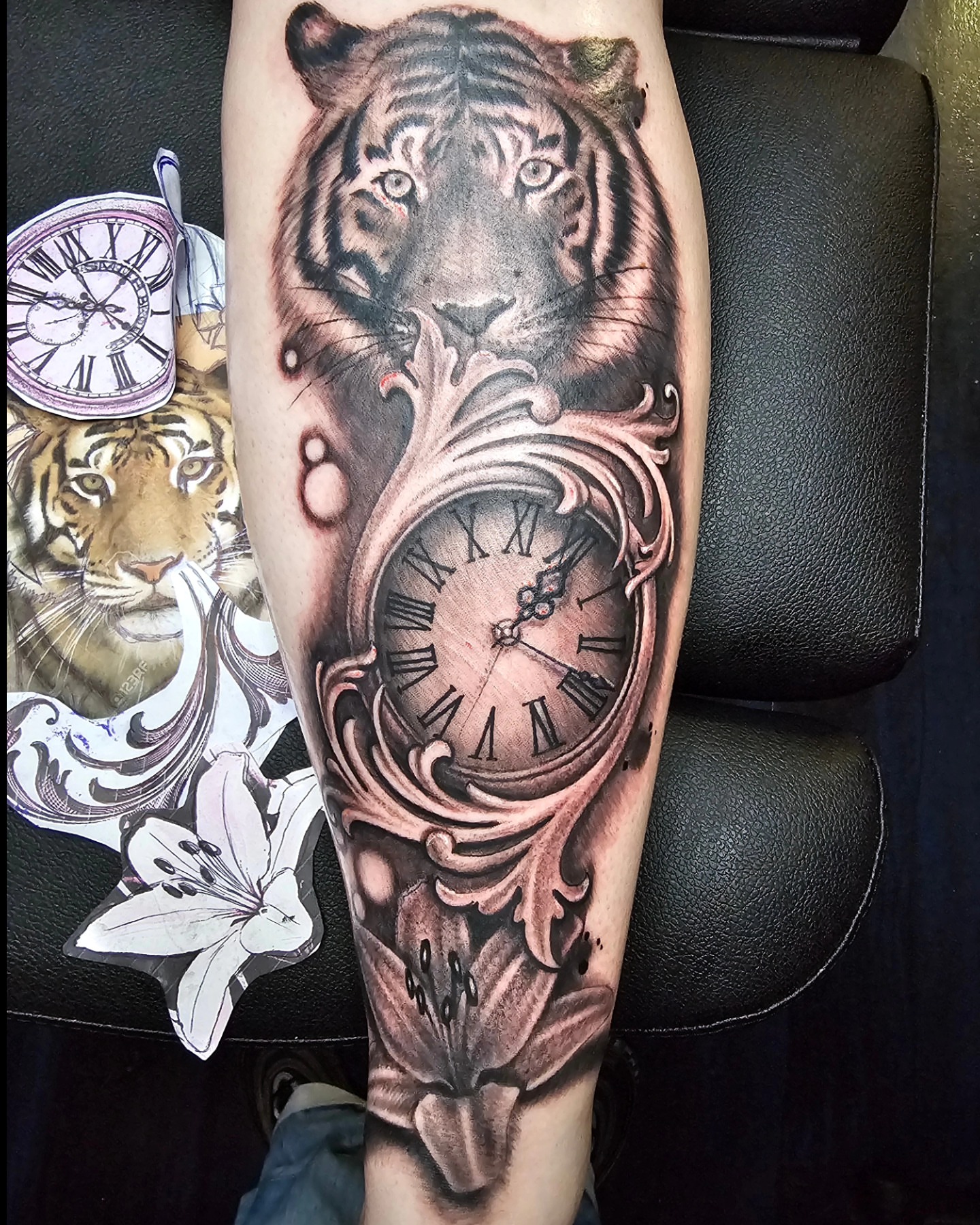 Tiger clock realism tattoo on the forearm by Germaine Sherman
