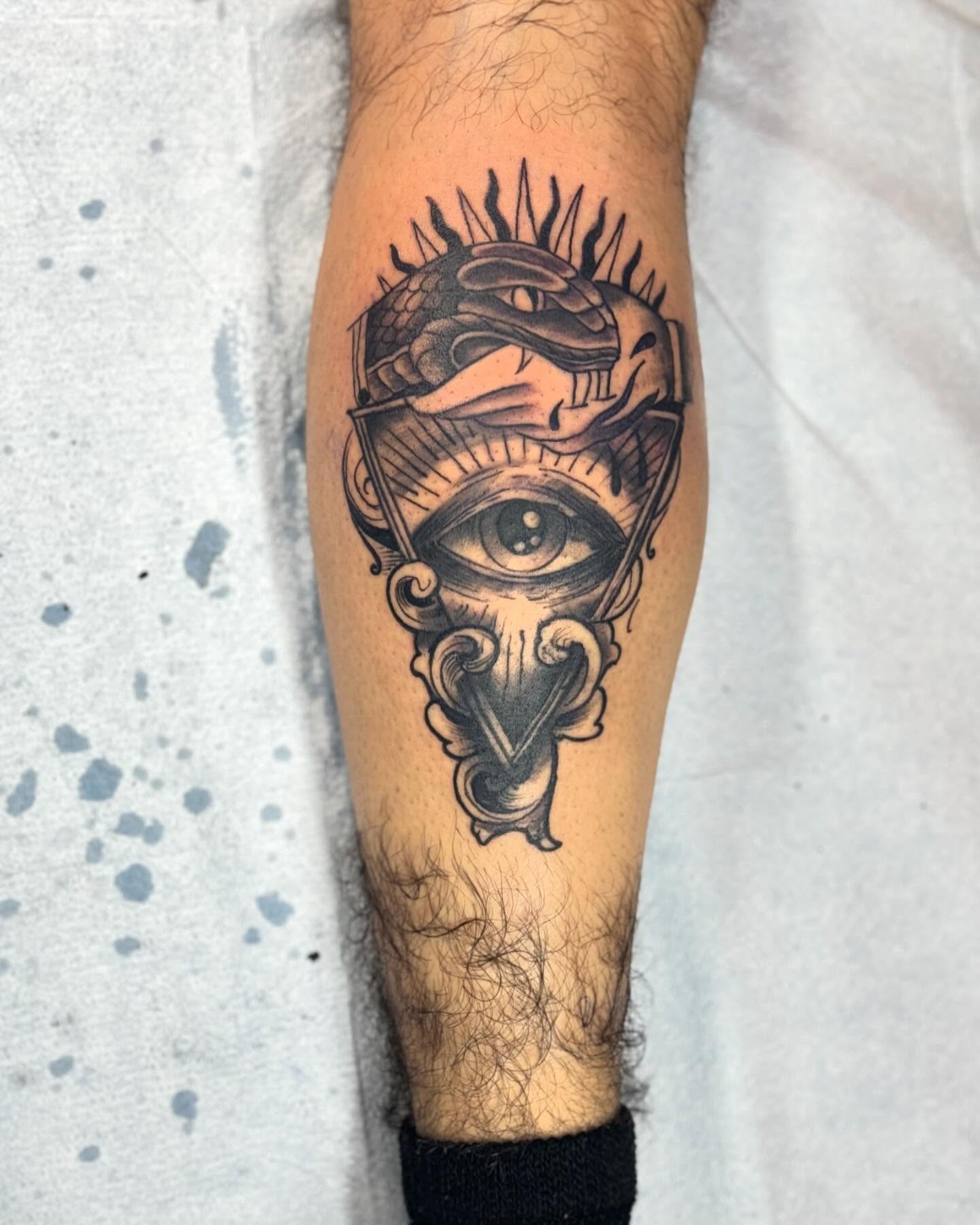 Eye and mask geometric tattoo on the forearm by Alejandro Zaragoza
