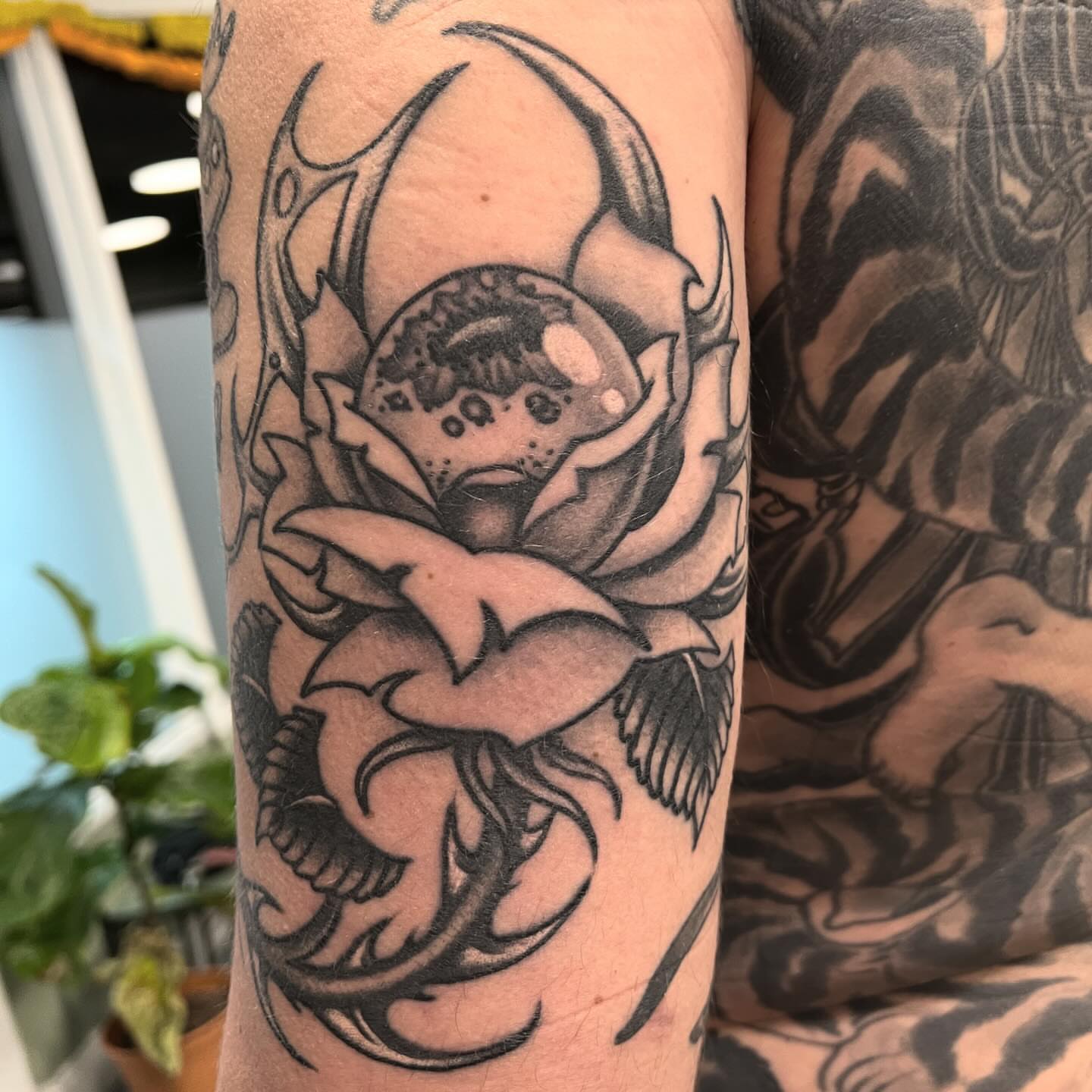 Flower with bubble black and grey tattoo on the forearm by Matt E.