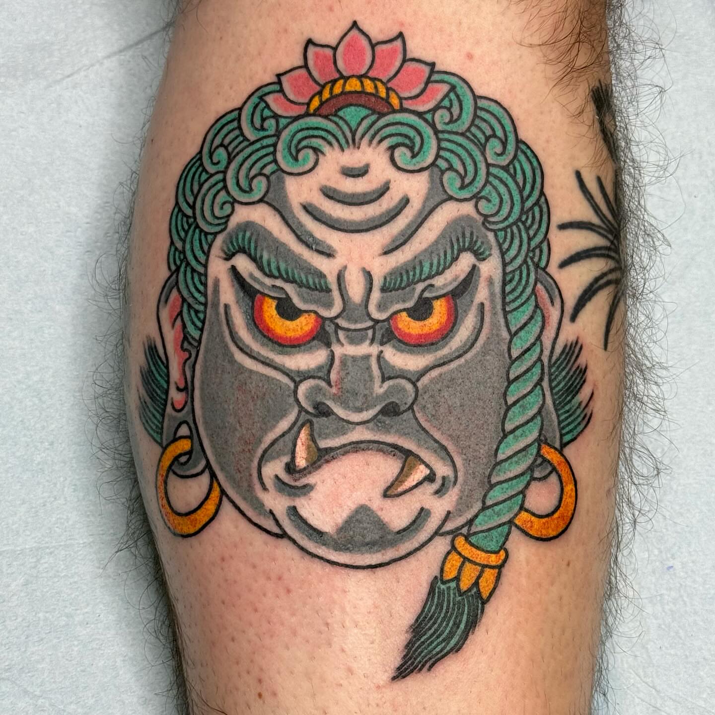 Demon mask American traditional tattoo on the forearm by Timothy Wood