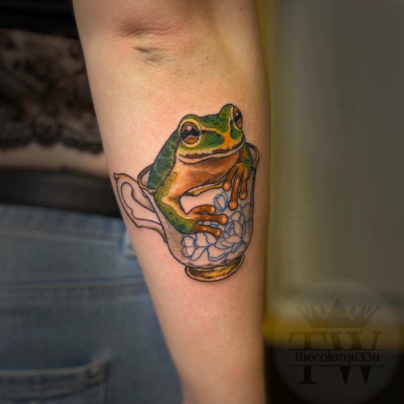 Frog in teacup realism tattoo on the forearm by Taylor Tha Color Queen
