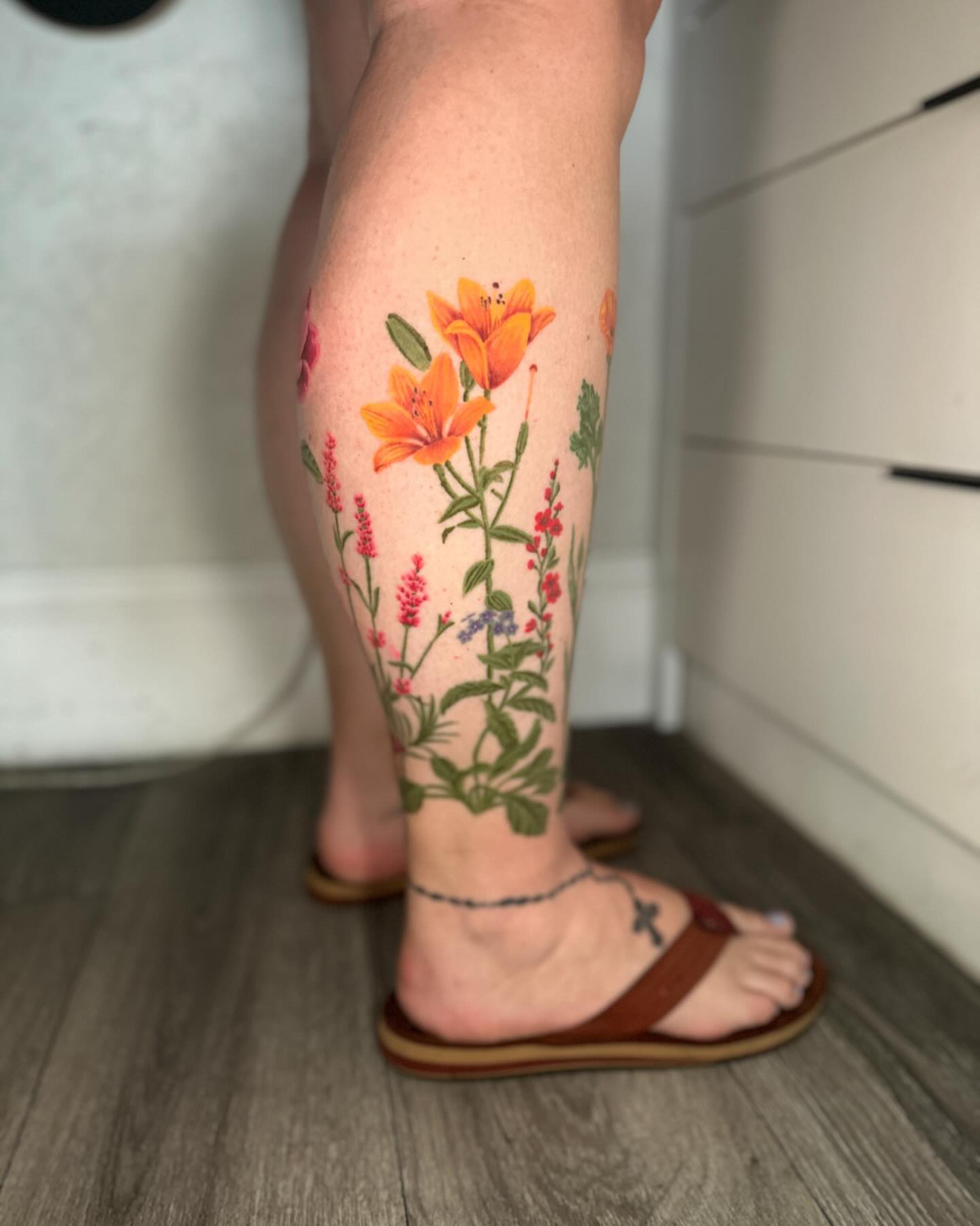 Floral arrangement realism tattoo on the calf by Stephen Hansen