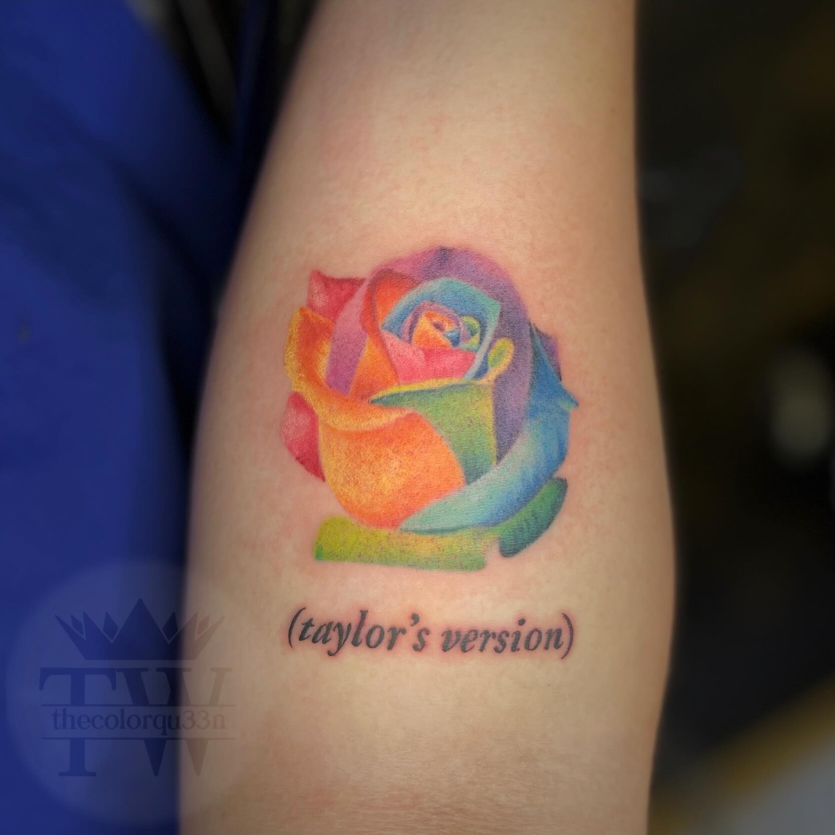 Rainbow rose watercolor tattoo on the forearm by Taylor Tha Color Queen