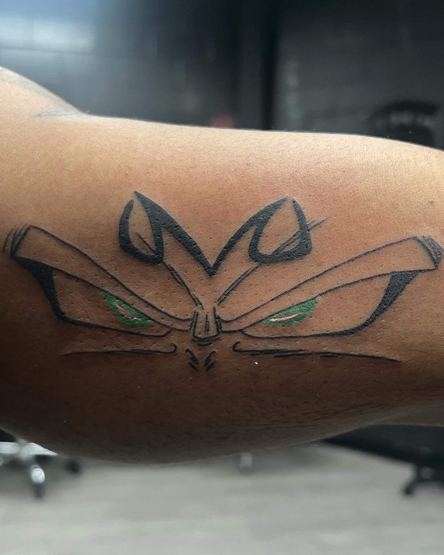 Mask geometric tattoo on the forearm by Kai
