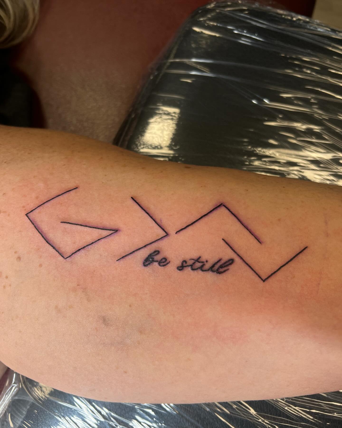Be still geometric tattoo on the forearm by Kai
