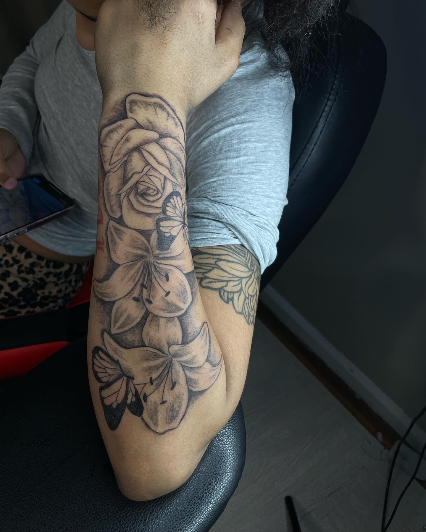 Flowers realism tattoo on the forearm by Dinero Inks