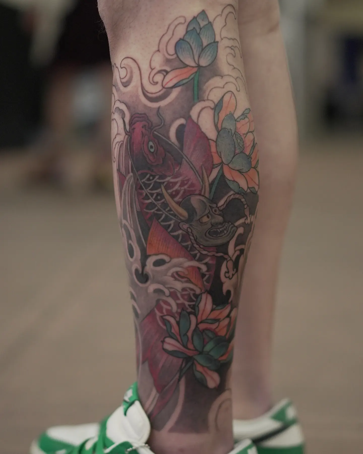 Koi fish and lotus flowers American traditional tattoo on the calf by zamix_traditional, San Francisco, California
